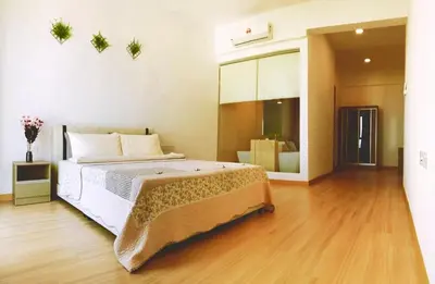 a bedroom with a large bed and a wooden floor at Luxury Seaview Family Suite by Little Cabin in George Town