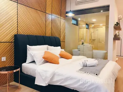 a bedroom with a large bed with orange and white pillows at Luxury Seaview Family Suite by Little Cabin in George Town