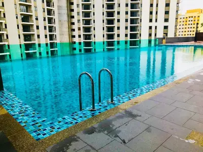 a swimming pool with blue water in a building at Luxury Seaview Family Suite by Little Cabin in George Town