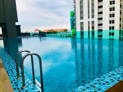 a swimming pool with blue tiles in a building at Luxury Seaview Family Suite by Little Cabin in George Town