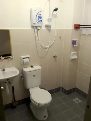 a bathroom with a white toilet and a sink at Fun Studio Pangkor in Pangkor
