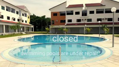 a swimming pool with a sign that reads closed swimming pools are under repair at Fun Studio Pangkor in Pangkor