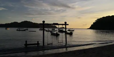 a group of boats in the water on a beach at Fun Studio Pangkor in Pangkor