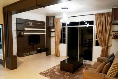 a living room with a couch and a television at Cameron View Apartment @ Crown Imperial Court Brinchang in Cameron Highlands