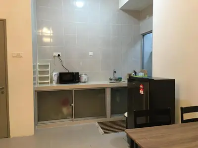 a kitchen with a counter with a microwave at Aalina's Comfort Home - Muslim Homestay in Cameron Highlands
