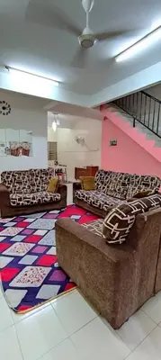 a living room with couches and a colorful rug at Homestay D-Zara in Ipoh