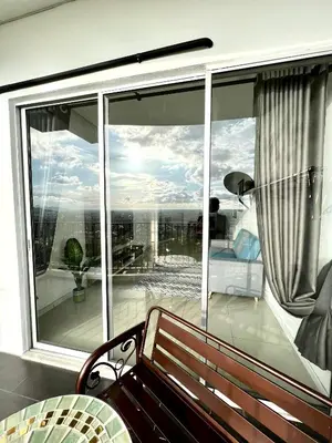 a balcony with a bench and a large window at Home Away from Home in Taiping - 3R4B Family & Group Friendly! in Taiping