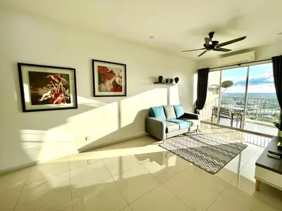 a living room with a couch and a ceiling fan at Home Away from Home in Taiping - 3R4B Family & Group Friendly! in Taiping