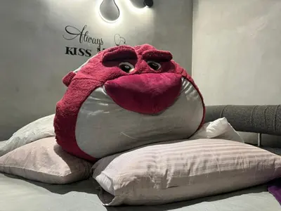 a large stuffed animal is sitting on a bed at Ipoh Zing Vale - Family & Couple Suite in Ipoh