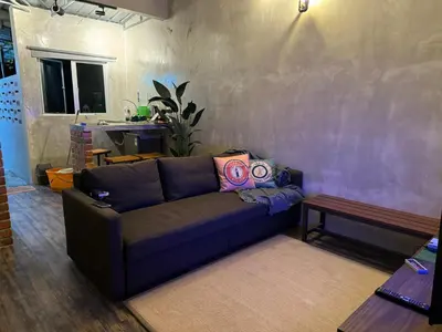 a living room with a couch and a table at Ipoh Zing Vale - Family & Couple Suite in Ipoh