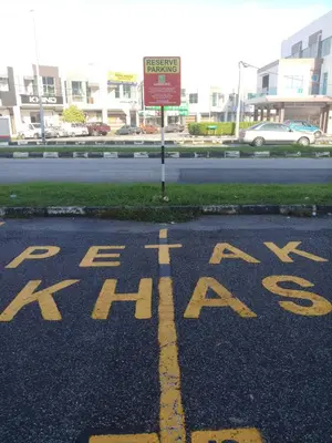 a parking lot with a sign that says eateat at K GARDEN HOTEL (IPOH) SDN BHD in Ipoh