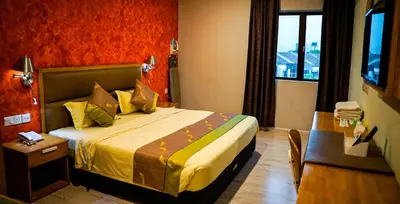 a hotel room with a bed and a table and a window at K GARDEN HOTEL (IPOH) SDN BHD in Ipoh