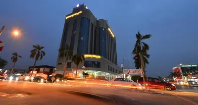 a large building with cars parked on a city street at night at Emerald Puteri Hotel in Sungai Petani