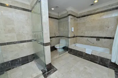 a bathroom with a shower and a tub and a toilet at Emerald Puteri Hotel in Sungai Petani