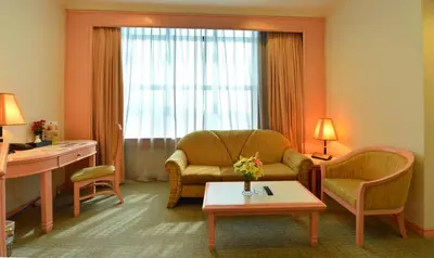 a living room with a couch and a table at Emerald Puteri Hotel in Sungai Petani