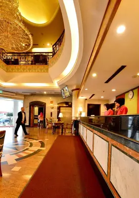 a lobby of a hotel with a bar and people at Emerald Puteri Hotel in Sungai Petani