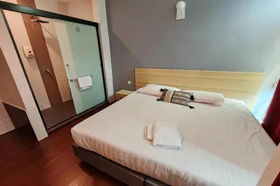 a bedroom with a bed with two towels on it at Hotel 18 Ipoh Aeon Mall in Ipoh