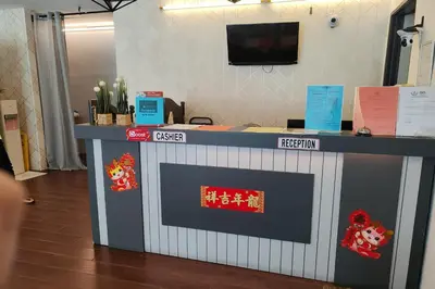 a reception desk with a blue and white at Hotel 18 Ipoh Aeon Mall in Ipoh