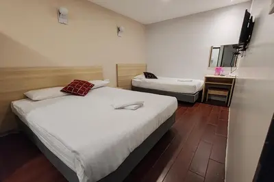 a hotel room with two beds and a mirror at Hotel 18 Ipoh Aeon Mall in Ipoh