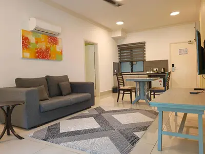 a living room with a couch and a table at RPGC Garden Hotel in Ipoh
