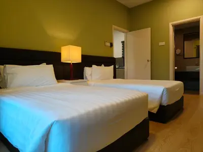 two large beds in a hotel room with at RPGC Garden Hotel in Ipoh