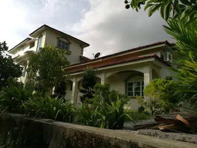 a house in the middle of a garden at Guesthouse Dragon Place in Taiping