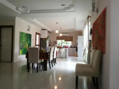 a dining room and kitchen with a table and chairs at Guesthouse Dragon Place in Taiping