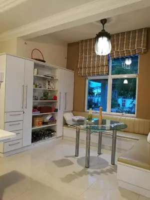 a kitchen with a table in the middle of a room at Guesthouse Dragon Place in Taiping