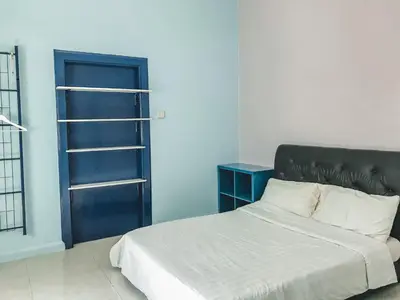 a bedroom with a bed and a blue door at Guesthouse Dragon Place in Taiping