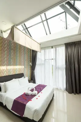 a bedroom with a bed and a large window at Rock Mountain in Raub
