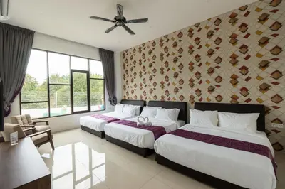 a hotel room with two beds and a ceiling fan at Rock Mountain in Raub