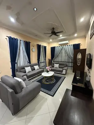 a living room with couches and a table at Idaman homestay in Bukit Mertajam