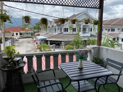 a patio with a table and chairs on a balcony at Makmur homestay in Taiping