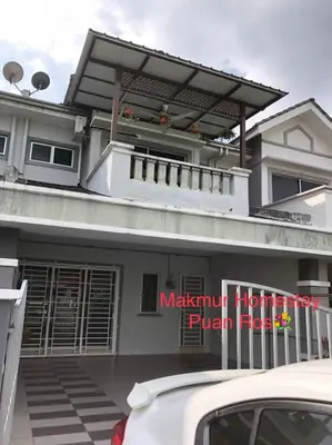 a white car parked in front of a house at Makmur homestay in Taiping