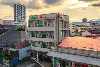 a building with a sign on it in a city at Apple Hotel Times Square in George Town