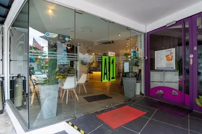 a store front with a purple and green storefront at Apple Hotel Times Square in George Town