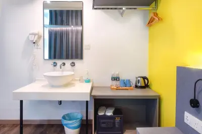 a bathroom with a sink and a mirror at Apple Hotel Times Square in George Town