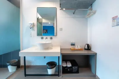 a bathroom with a sink and a mirror at Apple Hotel Times Square in George Town