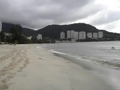 a sandy beach with buildings in the background at Tanjung Point Residences in George Town