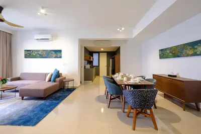 a living room with a table and a couch at Tanjung Point Residences in George Town