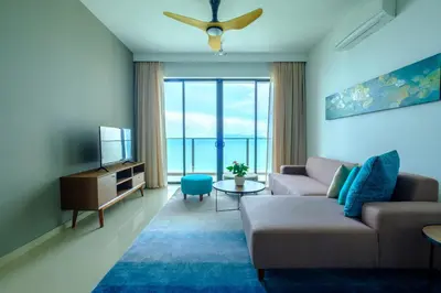 a living room with a couch and a tv at Tanjung Point Residences in George Town