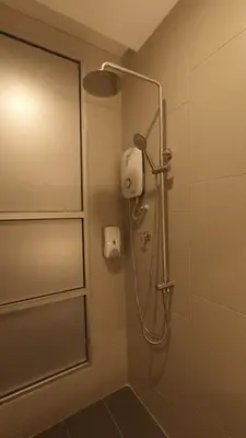 a shower in a bathroom with a glass door at U Design Hotel Kuala Lipis in Kuala Lipis