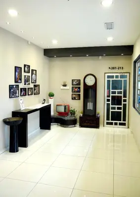 an office lobby with a desk and a clock on the wall at JV Hotel @ Bandar Tasek Mutiara in Simpang Ampat