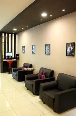 a waiting room with couches and a tv on a wall at JV Hotel @ Bandar Tasek Mutiara in Simpang Ampat