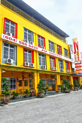 a yellow building with a sign that reads food soosaosa at JV Hotel @ Simpang Ampat in Simpang Ampat