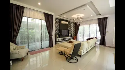 a living room with a couch and chairs and windows at The heaven in sunway ipoh in Ipoh