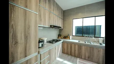a kitchen with wooden cabinets and a sink and a window at The heaven in sunway ipoh in Ipoh