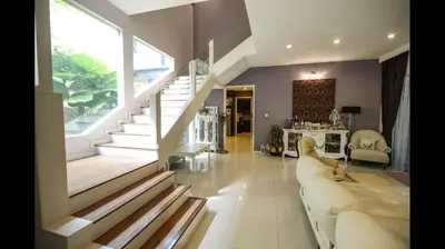 a living room with a couch and a staircase at The heaven in sunway ipoh in Ipoh