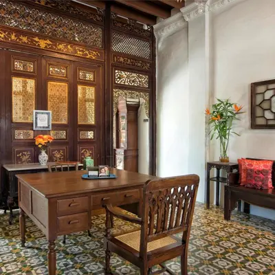 a room with a wooden desk and chairs and a table at Noordin Mews in George Town