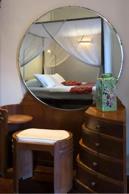 a bedroom with a mirror and a bed and a dresser at Noordin Mews in George Town